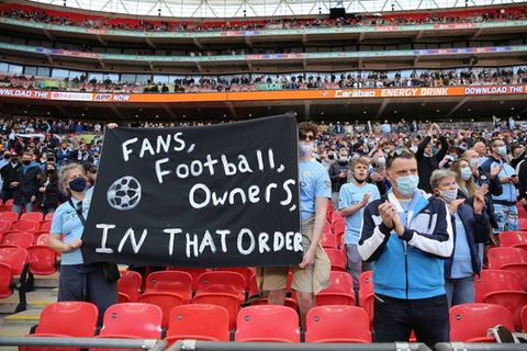 Fans von Manchester City halten ein Transparent aus Protest gegen die European Super League