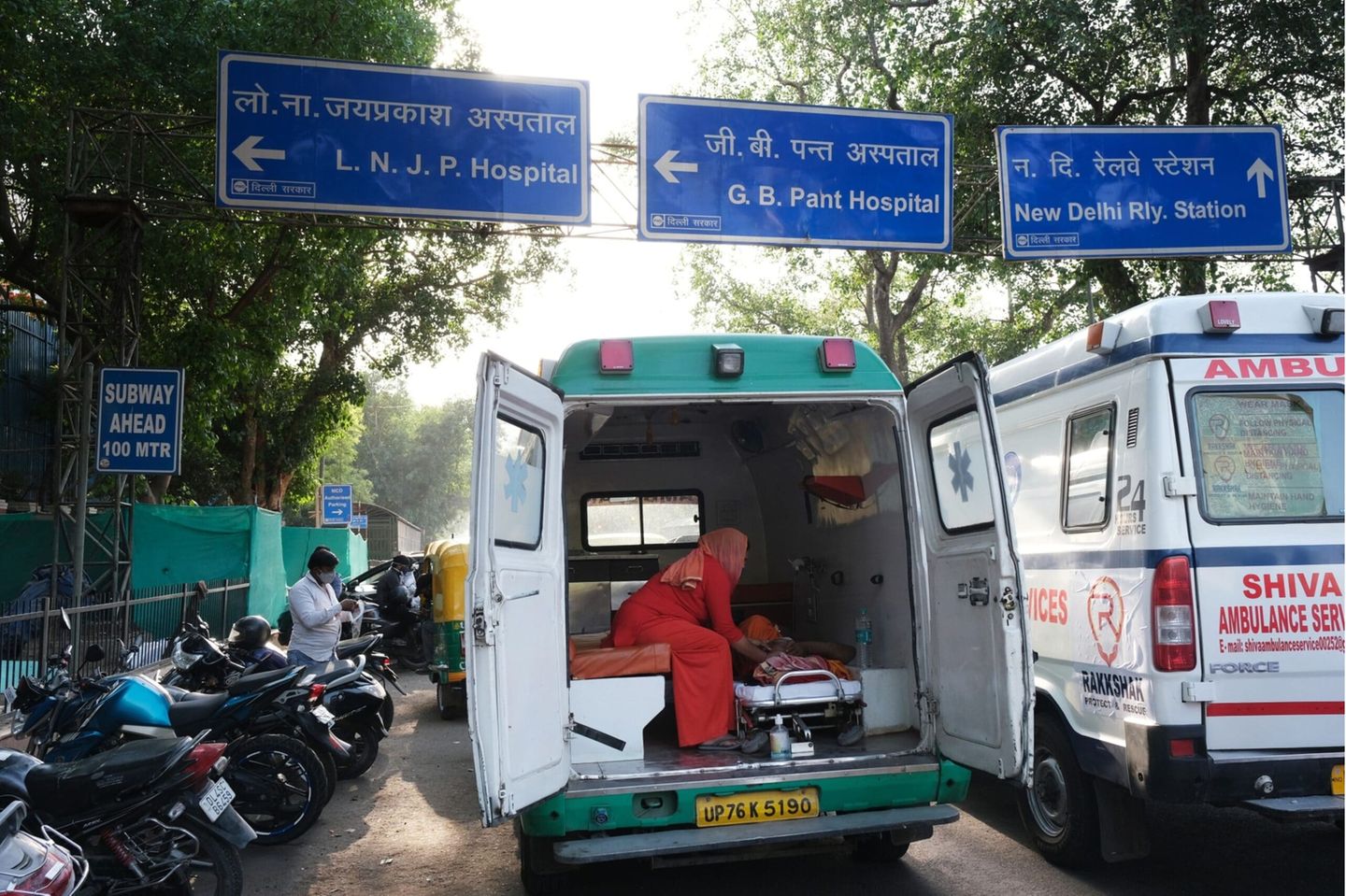 A Covid-19 patient is attended to in ambulance while waiting at the main entrance of the Lok Nayayak Jaiprakash Hospital in New Delhi, India, on Sunday, April 25, 2021. Noting that at least six high courts are hearing disputes about Covid-19 management including oxygen shortages, the Supreme Court on Thursday asked India's federal government to come up with a national plan for the distribution of essential supplies and services.