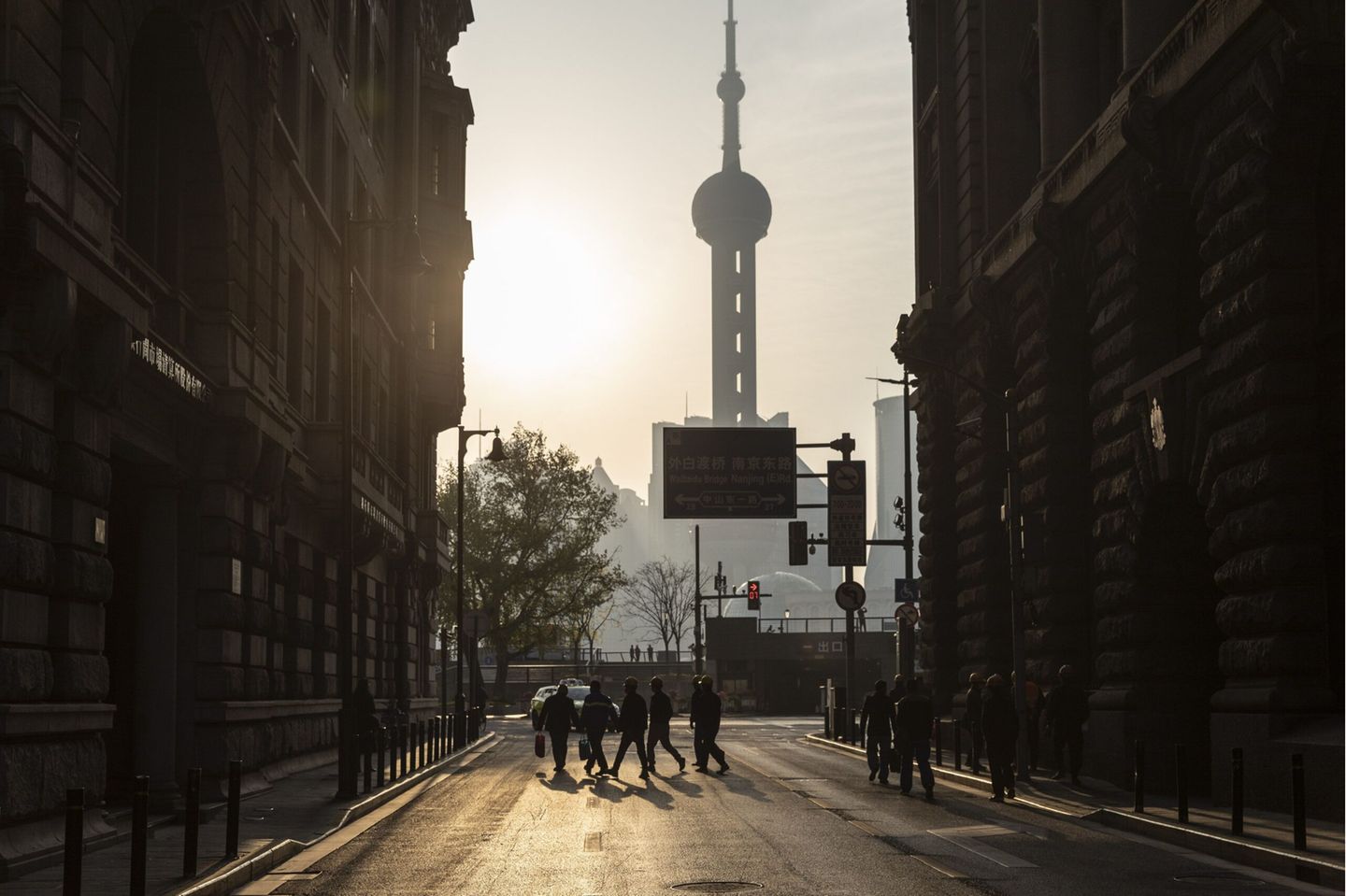 Construction workers cross a road near the Bund in Shanghai, China, on Saturday, April 10, 2021. Photographer: Qilai Shen/Bloomberg