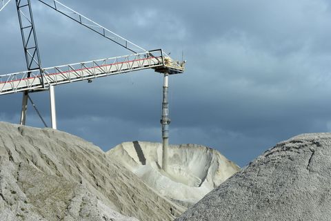 Lithium ore falls from a chute onto a stockpile at a Talison Lithium Ltd. facility, a joint venture between Tianqi Lithium Corp. and Albemarle Corp., in Greenbushes, Australia, on Thursday, Aug. 3, 2017. Rising Chinese demand for lithium-ion batteries needed for electric vehicles and energy storage is driving significant price gains and an asset boom in Australia, already the world's largest lithium producer. Photographer: Carla Gottgens/Bloomberg via Getty Images