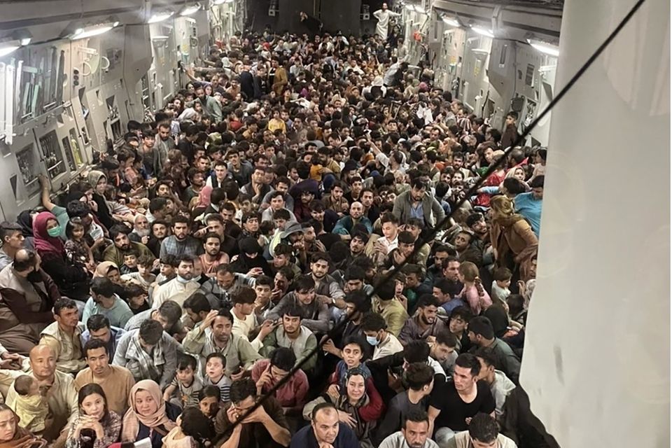 Afghan citizens pack inside a U.S. Air Force C-17 Globemaster III, as they are transported from Hamid Karzai International Airport in Afghanistan, Sunday, Aug. 15, 2021. The Taliban on Sunday swept into Kabul, the Afghan capital, after capturing most of Afghanistan. (Capt. Chris Herbert/U.S. Air Force via AP)