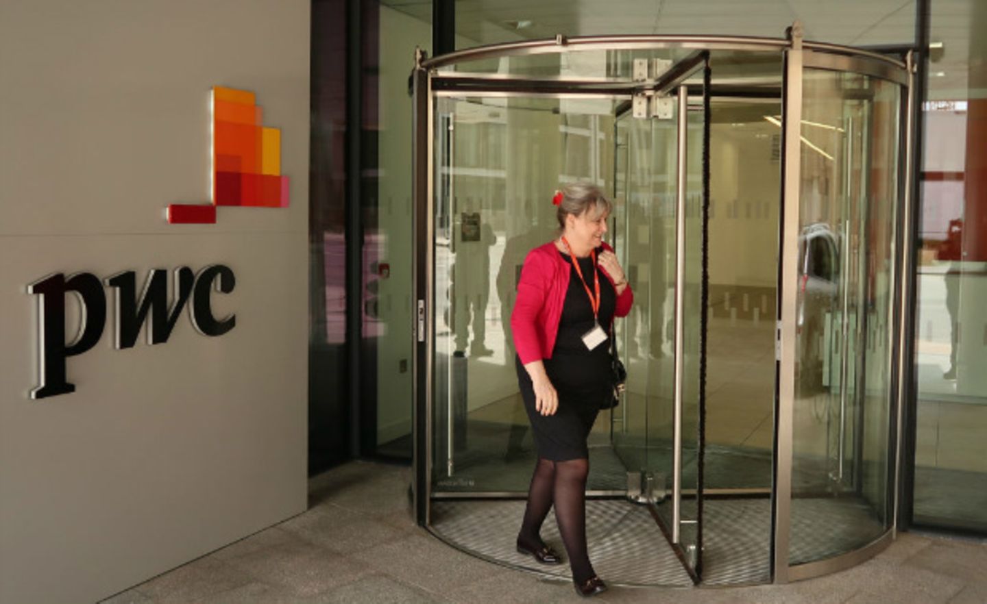 Eine Frau verlässt ein Büro der Unternehmensberatung PWC