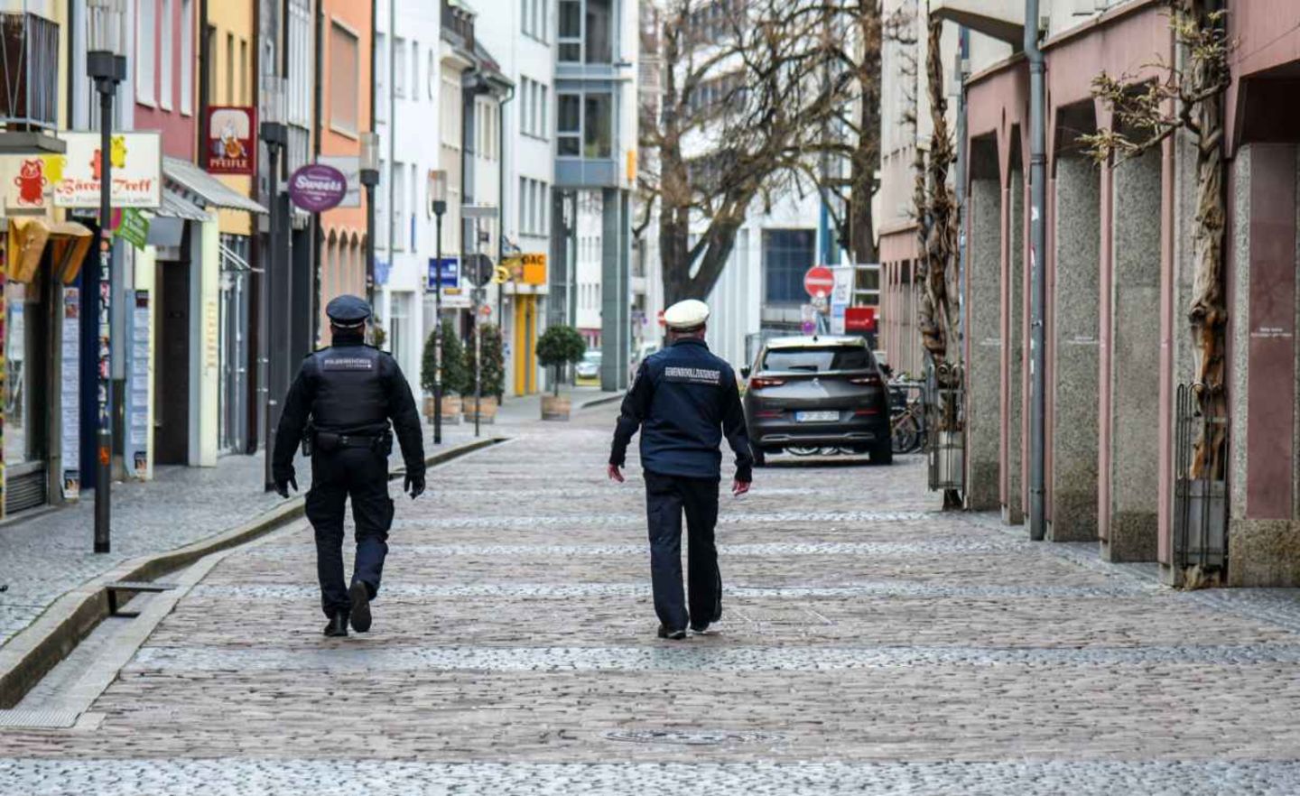 Angehörige des Gemeindevollzugsdiensts patrouillieren durch die weitgehend verwaiste Innenstadt in Freiburg zur Kontrolle der Ausgangsbeschränkungen Freiburg hatte als erste Großstadt zweiwöchige Ausgangsbeschränkungen verhängt