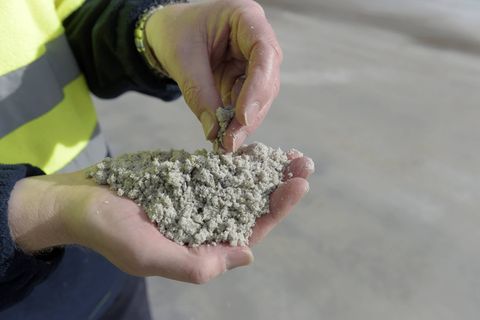An employee holds processed lithium for a photograph in Australia. Photographer: Carla Gottgens/Bloomberg
