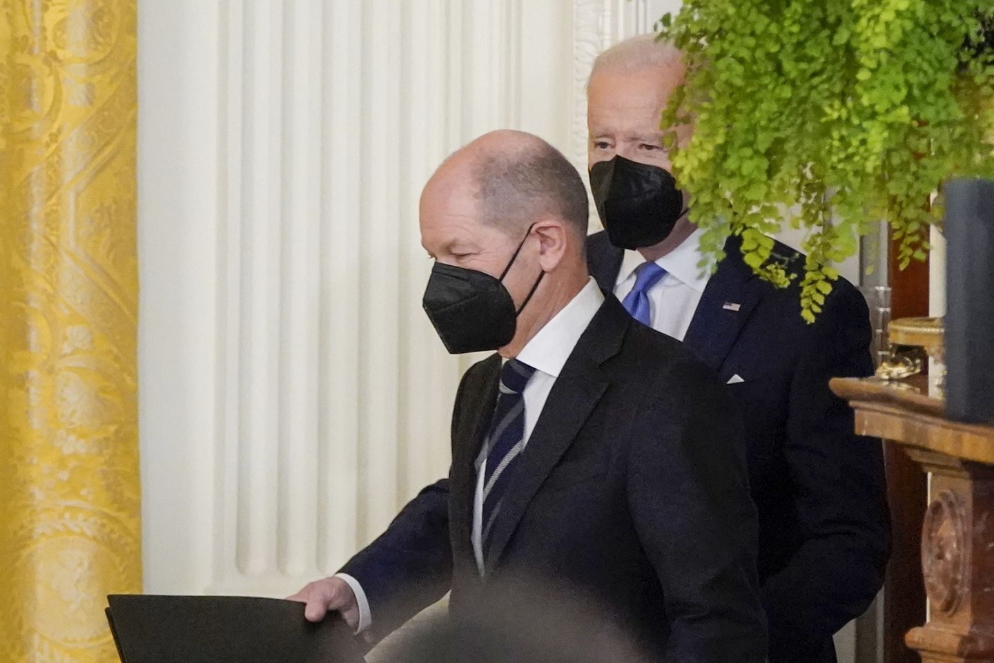 President Joe Biden and German Chancellor Olaf Scholz arrive for a news conference in the East Room of the White House, Monday, Feb. 7, 2022, in Washington. (AP Photo/Alex Brandon)
