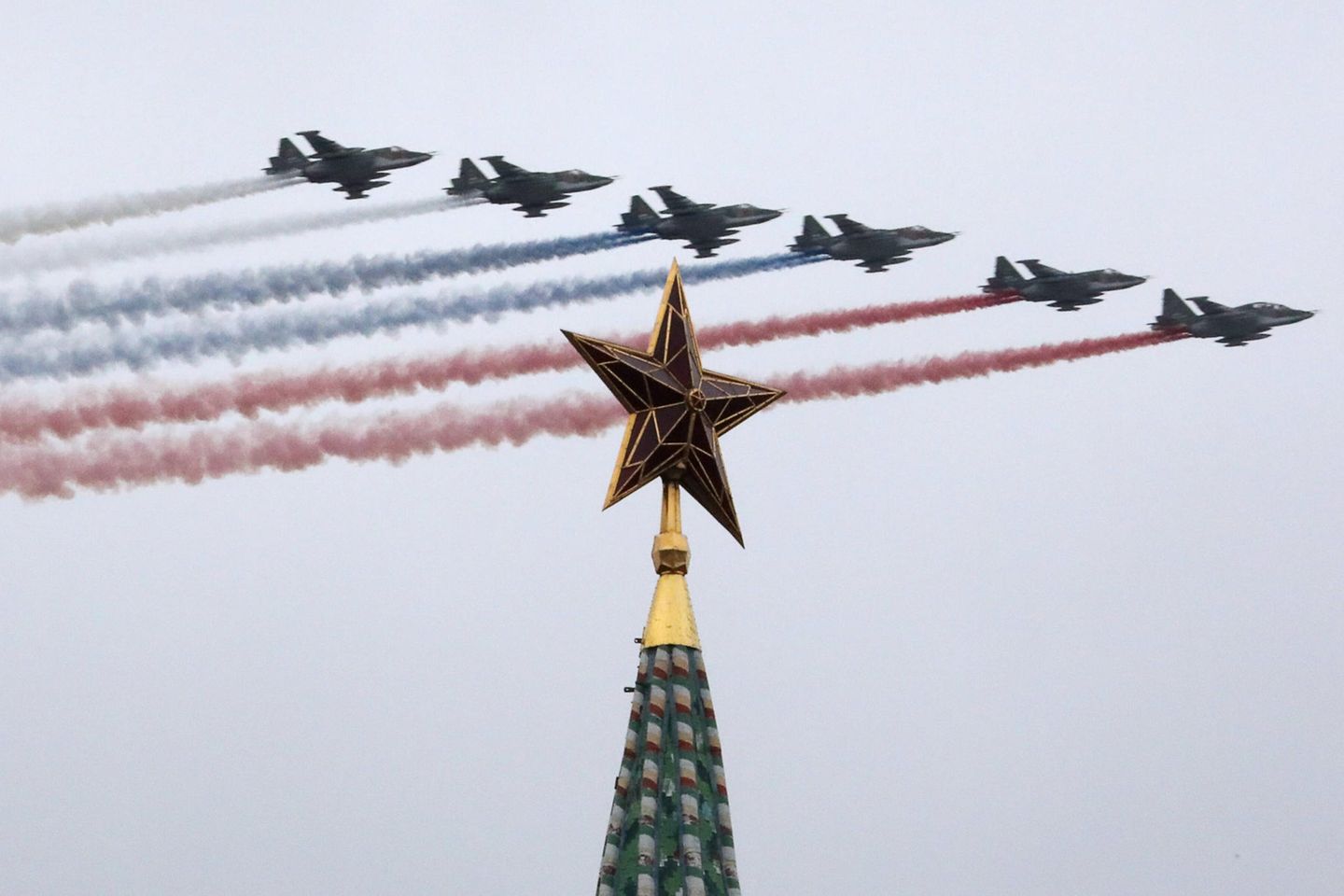 Sukhoi Su-25BM jet aircraft leave a trail in the Russian national colours as they fly in formation by a Moscow Kremlin tower during a Victory Day air show marking the 76th anniversary of the victory over Nazi Germany in the World War II.