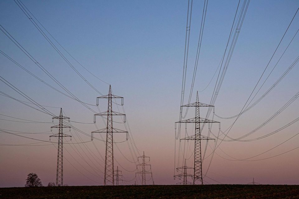 Strommasten einer Stromtrasse im Sonnenuntergang