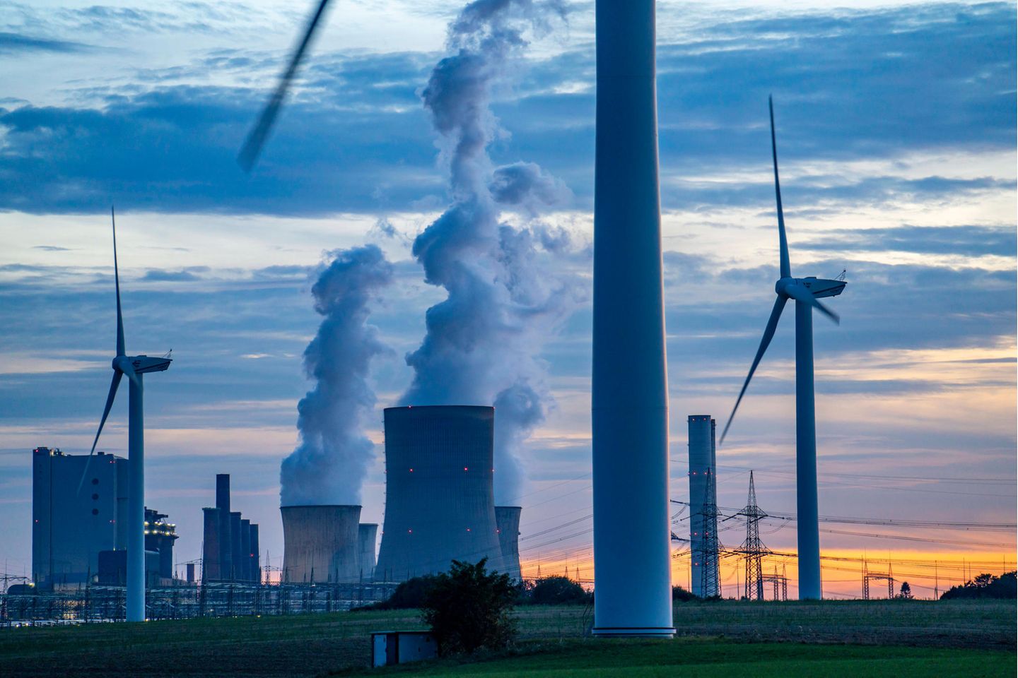 Braunkohle-Kraftwerk Niederaußem mit Windrädern im Vordergrund