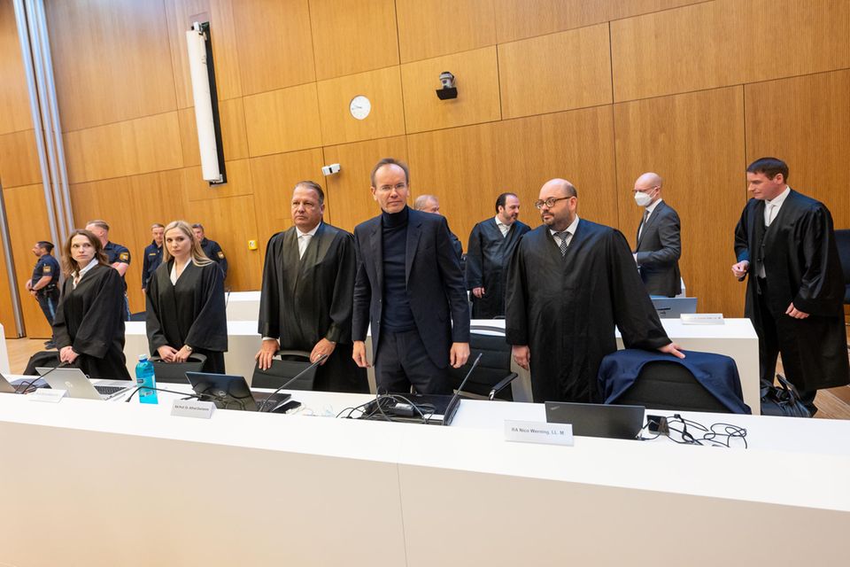 Markus Braun (Mitte) zwischen seinen Anwälten Alfred Dierlamm (links neben Braun) und Nico Werning (rechts neben Braun). Hinter Werning steht der Mitangeklagte Oliver Bellenhaus (Zweiter von rechts, mit Maske)
