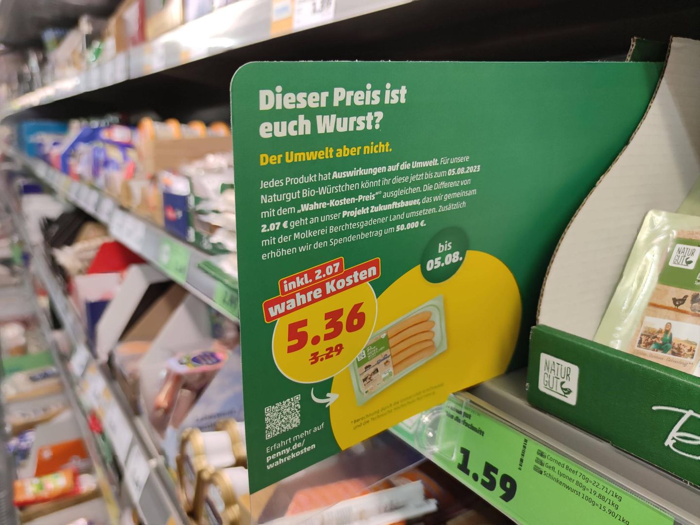 In einer Filiale von Penny hängt ein Preisschild mit der Aufschrift „Wahre Kosten“