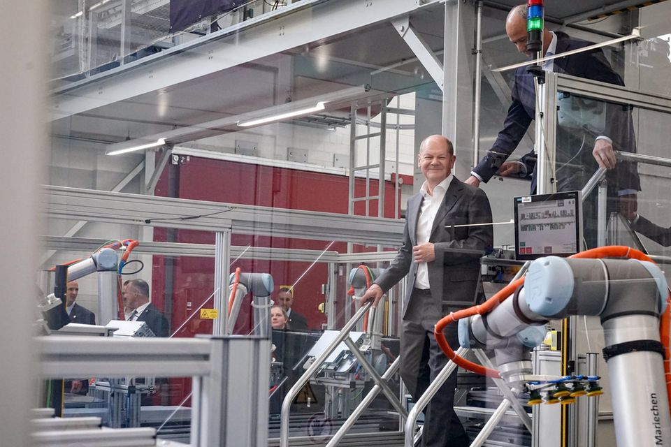 Olaf Scholz geht eine Treppe runter im Siemens-Werk in Erlangen