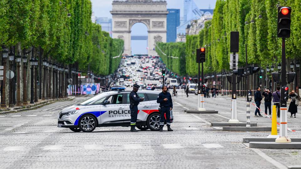 Polizisten auf dem Place de la Concorde. Die Champs-Elysee mit dem Arc de Triomphe im Hintergrund ist teilweise gesperrt