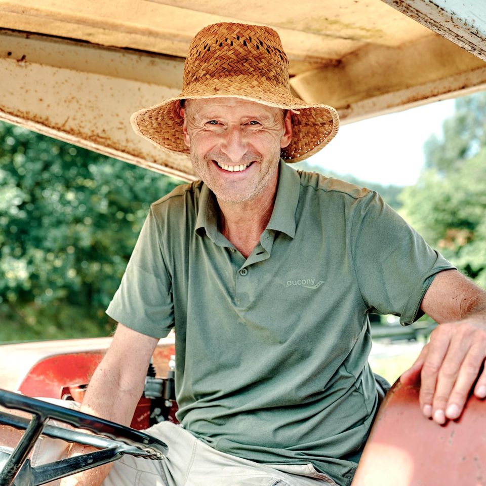 Ex-VW-Chef Herbert Diess sitzt auf einem Trecker