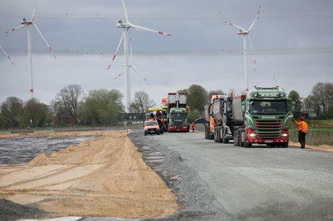Baustellenfahrzeuge sind bei Asphaltarbeiten auf dem künftigen Northvolt-Gelände in Heide tätig