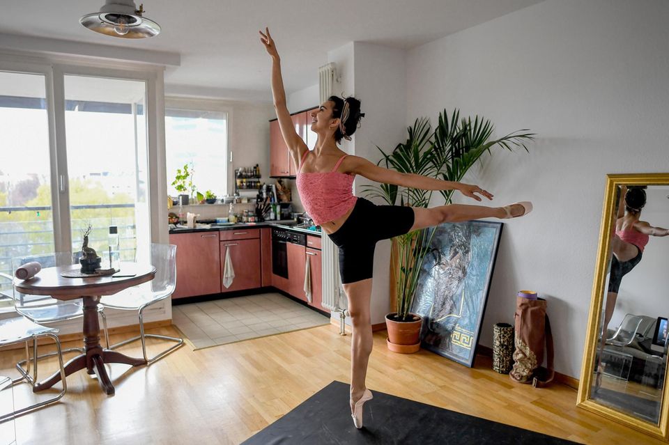 Eine Frau tanzt Ballett in ihrer Einzimmerwohnung in Berlin