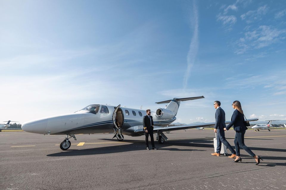 Eine Frau und ein Mann gehen zu einem Privatjet