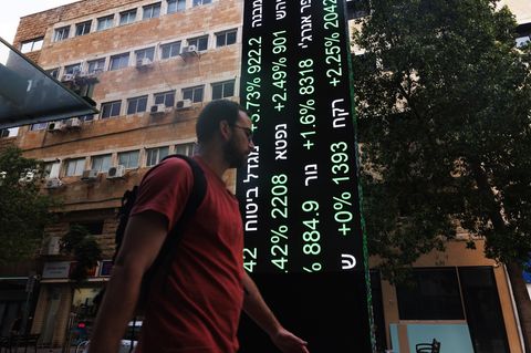 Ein Mann geht an einer Kurstafel der Börse in Tel Aviv vorbei